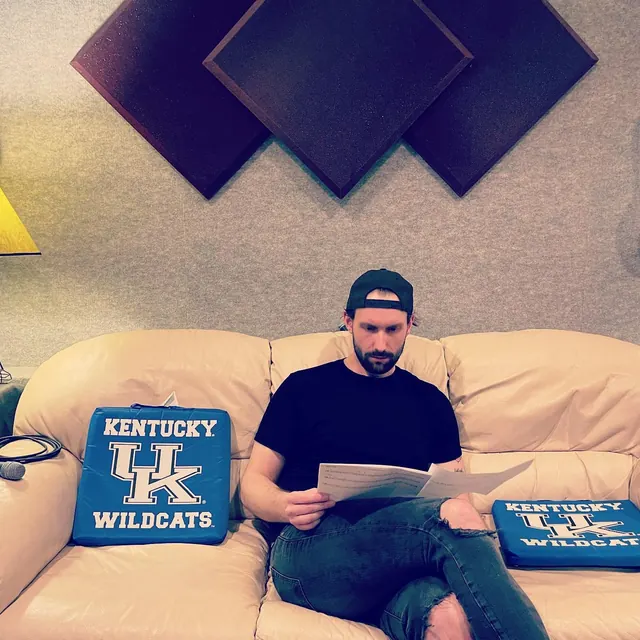 Musician reading a chart on the control room couch