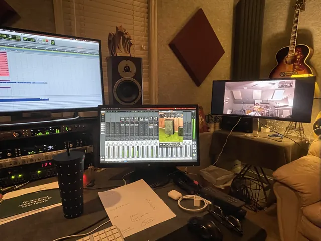 Wide view of the control room desk with Pro Tools, the mixer screen and monitors