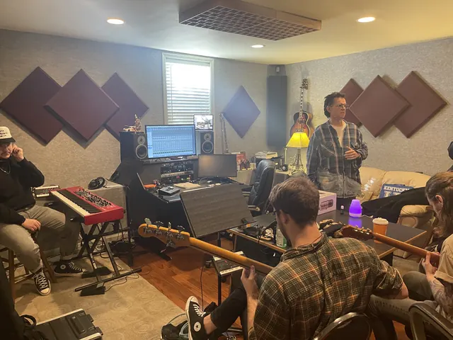 Band gathered in the control room during a session