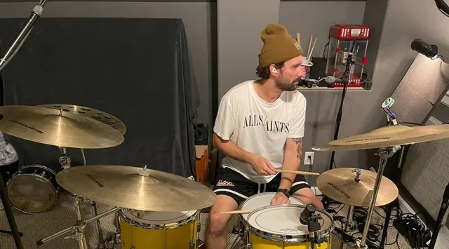 Drummer tracking on a yellow drum kit in the drum room
