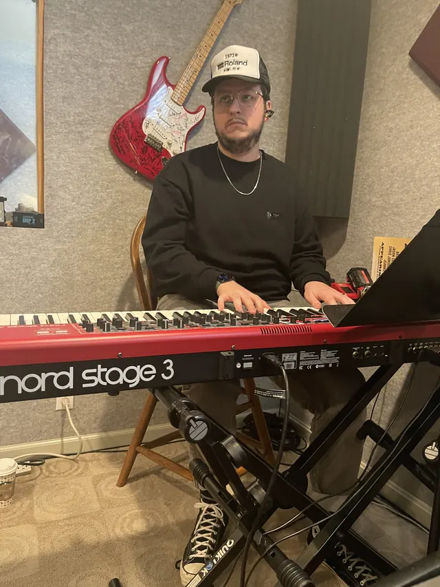 Keyboard player tracking on a red Nord Stage 3