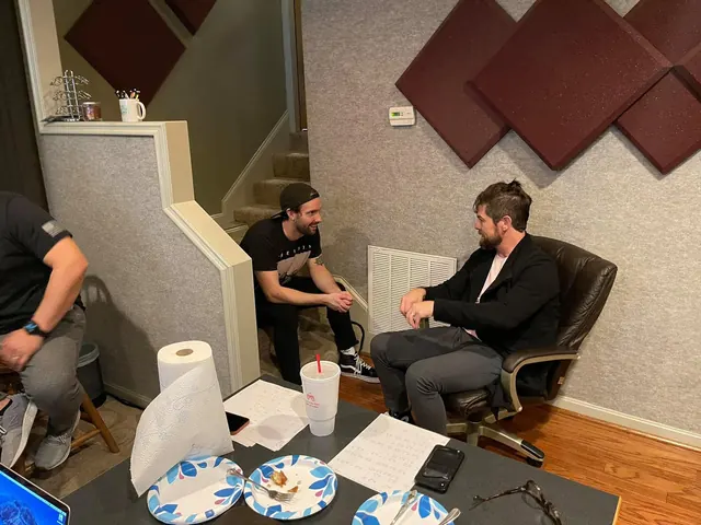 Musicians talking between takes in the lounge area