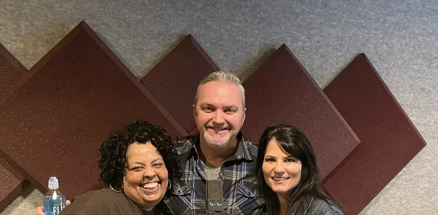 Terry with two singers in front of the acoustic panels after a session