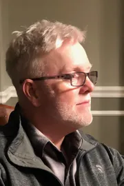 Terry today, in glasses and a gray jacket, seen in profile